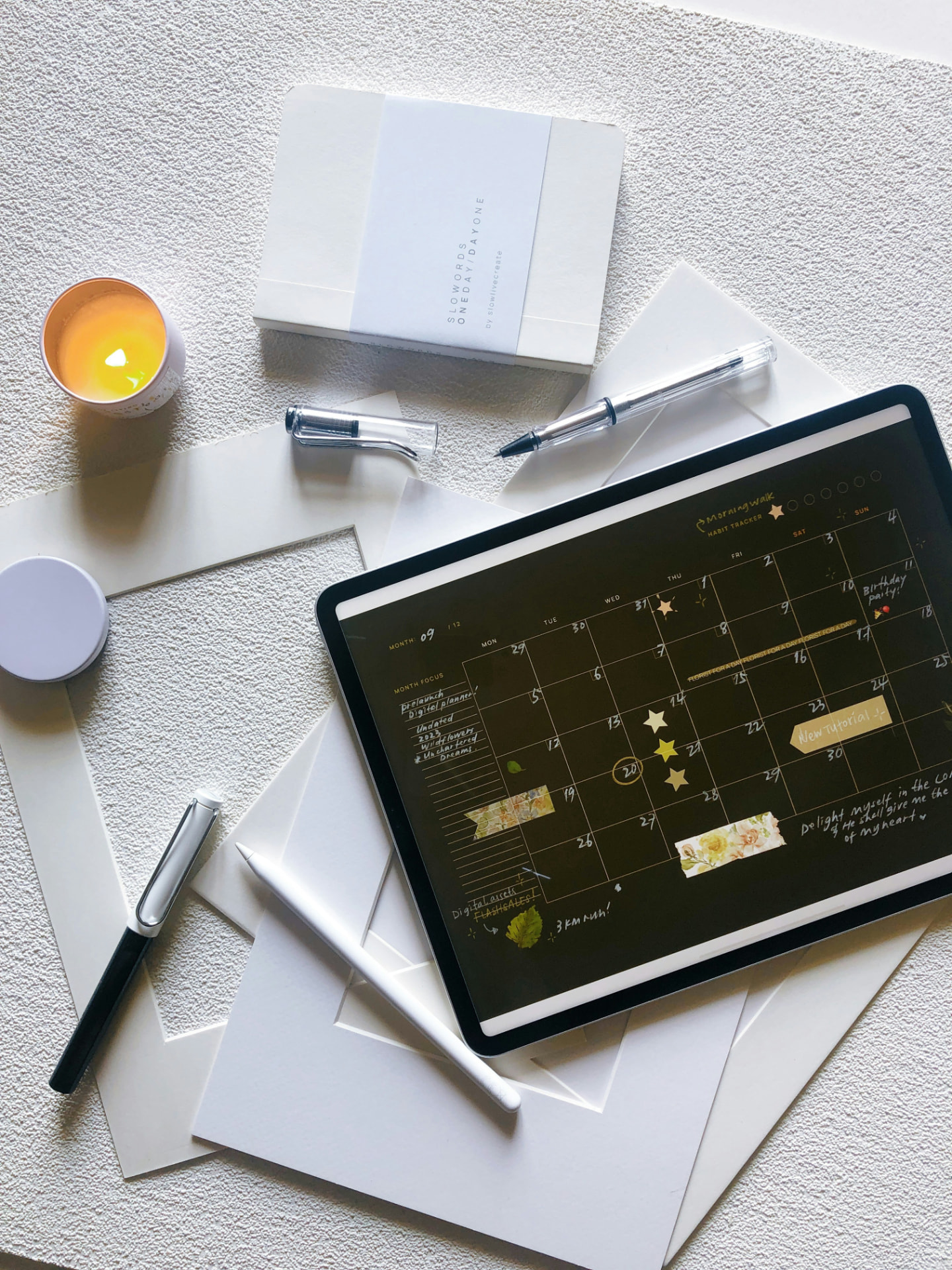 Digital planner open on a tablet beside notebooks and pens, representing structured five-year educational planning